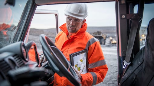 Man in oranje overall met tablet