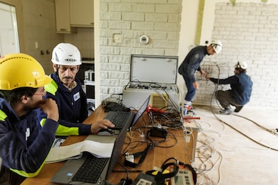 Worker testing house research masonry