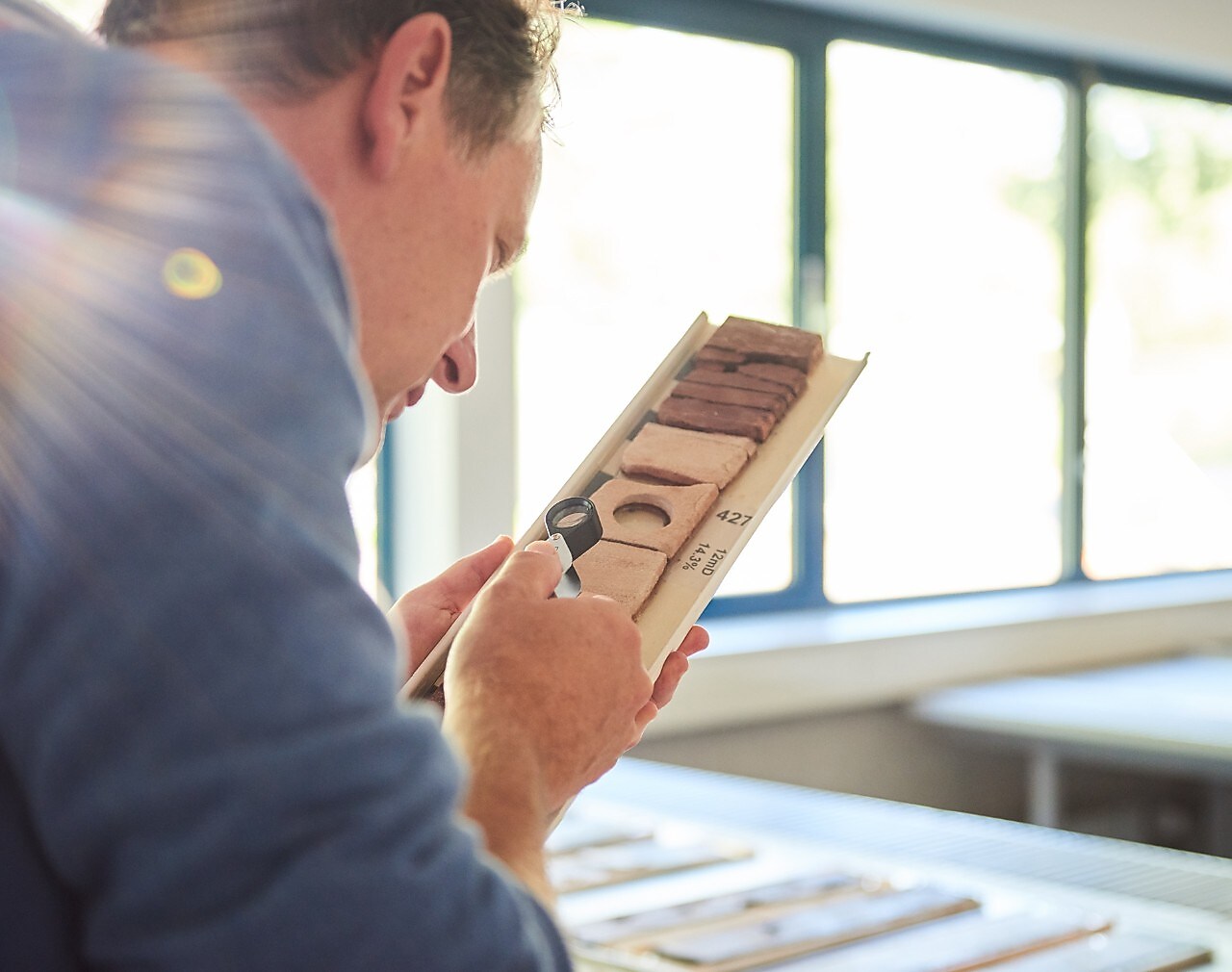  Man examines soil samples using a magnifying glass