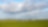 Groene weilanden met daarin een gaswinningslocatie onder een blauwe lucht